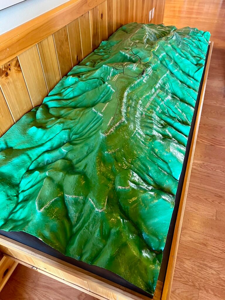 3D topographic model of Mount Magazine area inside the lodge, showing trails, campground, and Signal Hill elevation markers.