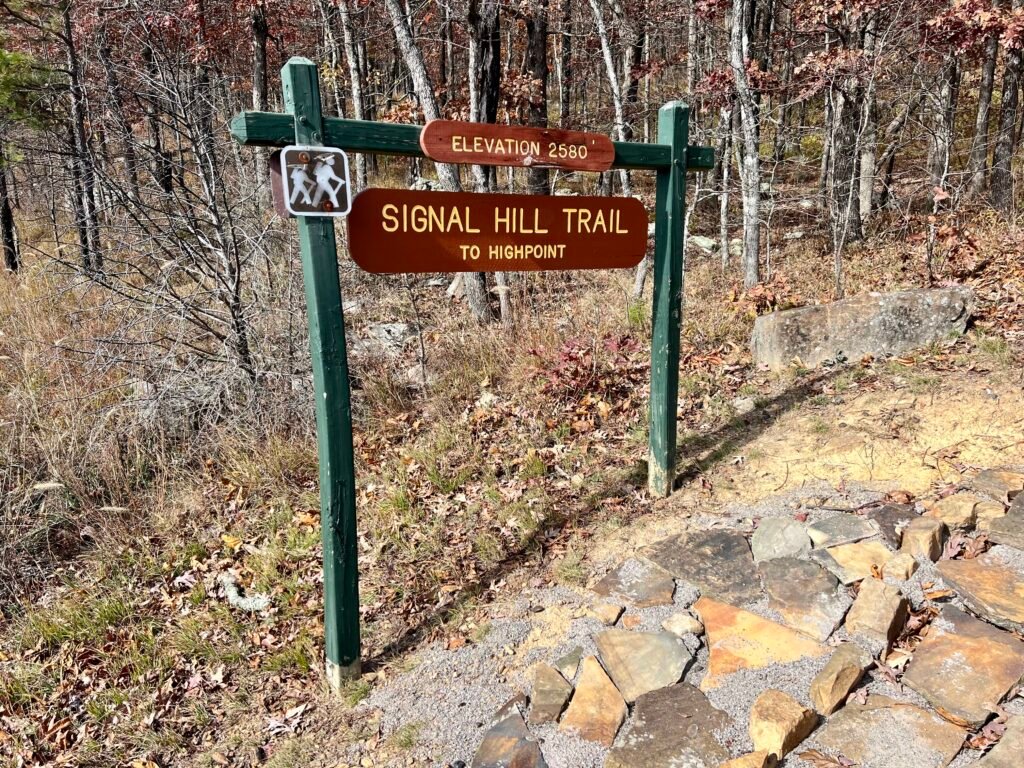 Wooden Signal Hill Trail sign showing elevation 2,580 feet at Mount Magazine State Park.