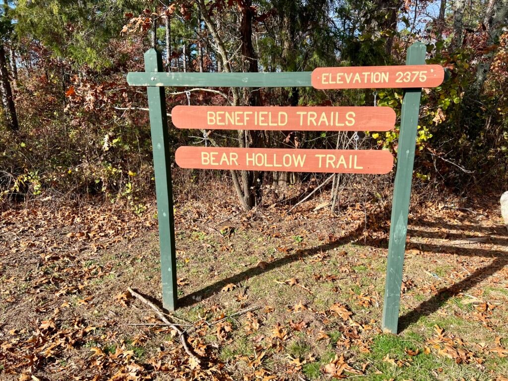 Benefield Trails and Bear Hollow Trail sign at Mount Magazine parking lot, elevation 2,375 feet
