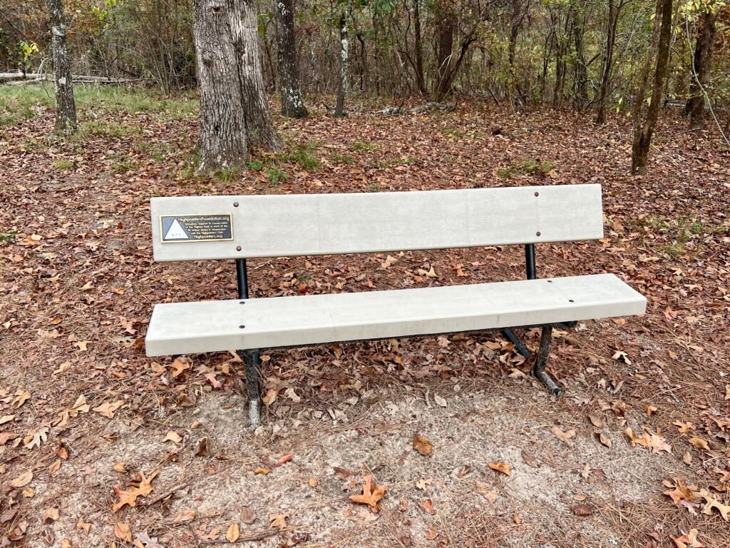 Highpointers Foundation bench at Driskill Mountain summit surrounded by fallen autumn leaves