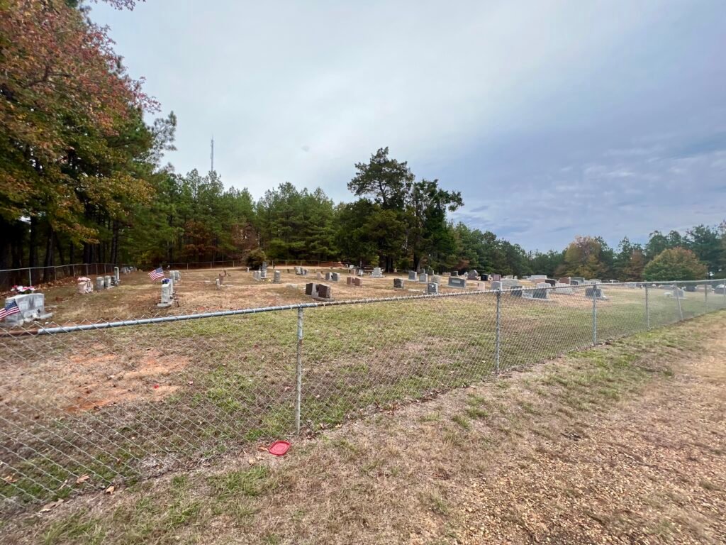 Driskill Memorial Cemetery with headstones and American flags beside Mt. Zion Presbyterian Church in Bienville Parish.
