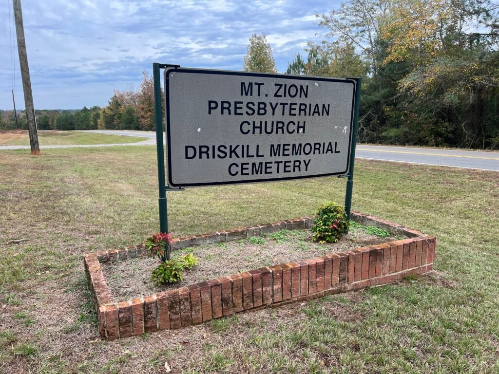 Roadside sign reading “Mt. Zion Presbyterian Church – Driskill Memorial Cemetery” along Louisiana Route 507.
