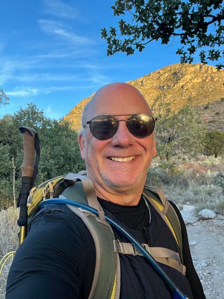 Hiker with backpack at the start of Guadalupe Peak Trail in Guadalupe Mountains National Park.