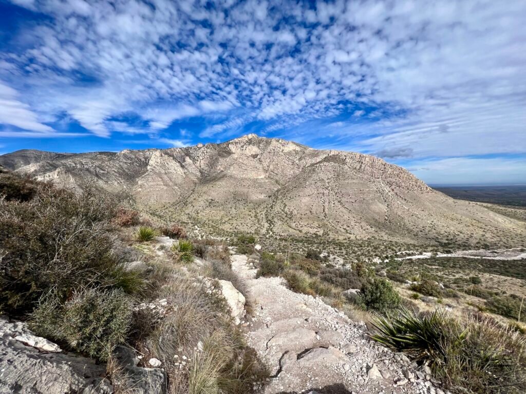 Final view of Guadalupe Peak and surrounding desert landscape before descending to the trailhead