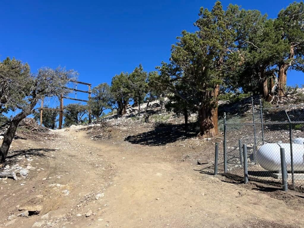 Final climb toward Bertha Peak with communications buildings and rocky trail