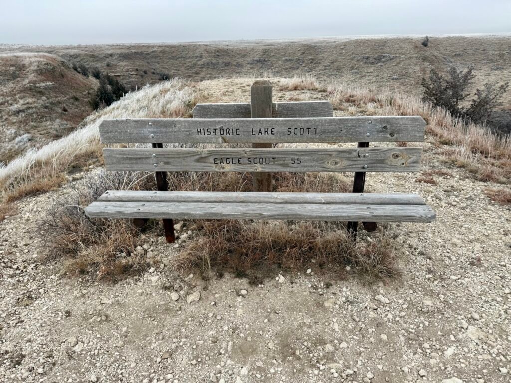 Bench at Buzzard’s Point reading “Historic Lake Scott – Eagle Scout ’55” at the bluff overlook