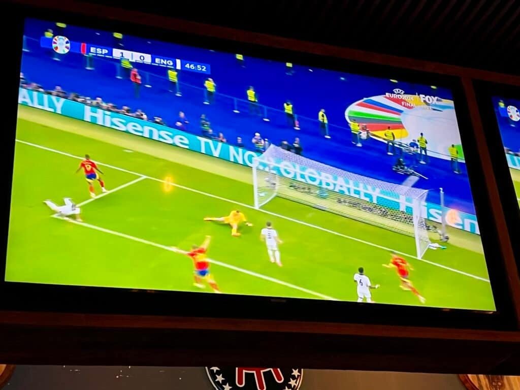 Spain scores against England during the Euro 2024 final shown on bar TVs