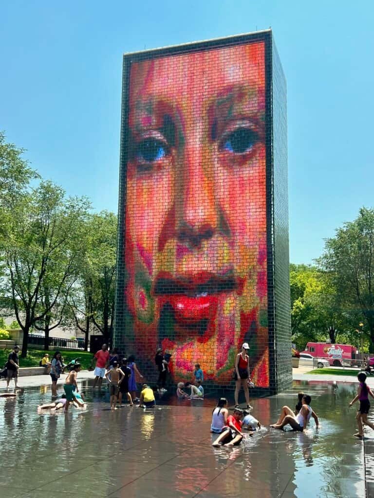 Children playing in the shallow reflecting pool at Crown Fountain in Millennium Park, Chicago