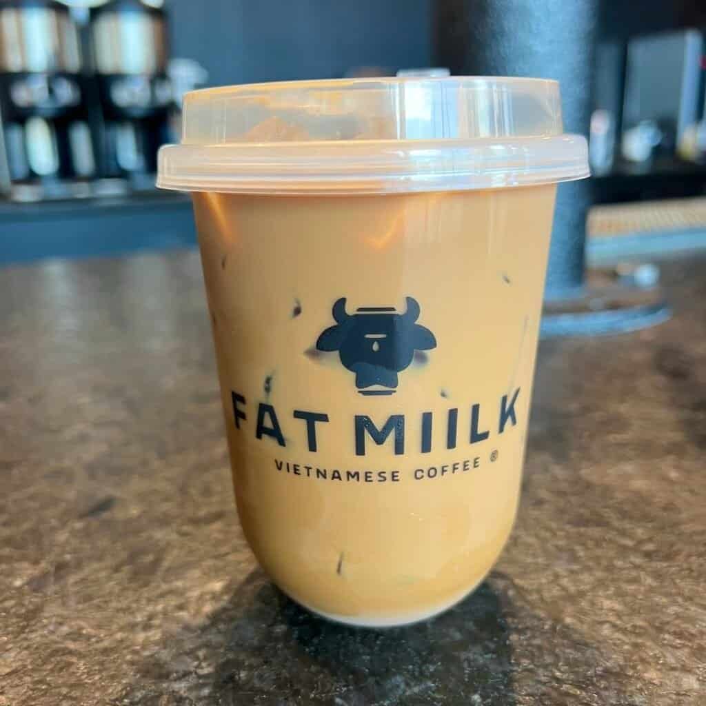 Iced Vietnamese coffee from Fat Miilk served in a clear cup on the counter