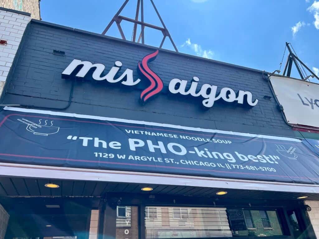 Exterior sign and banner at Miss Saigon Vietnamese restaurant in Chicago