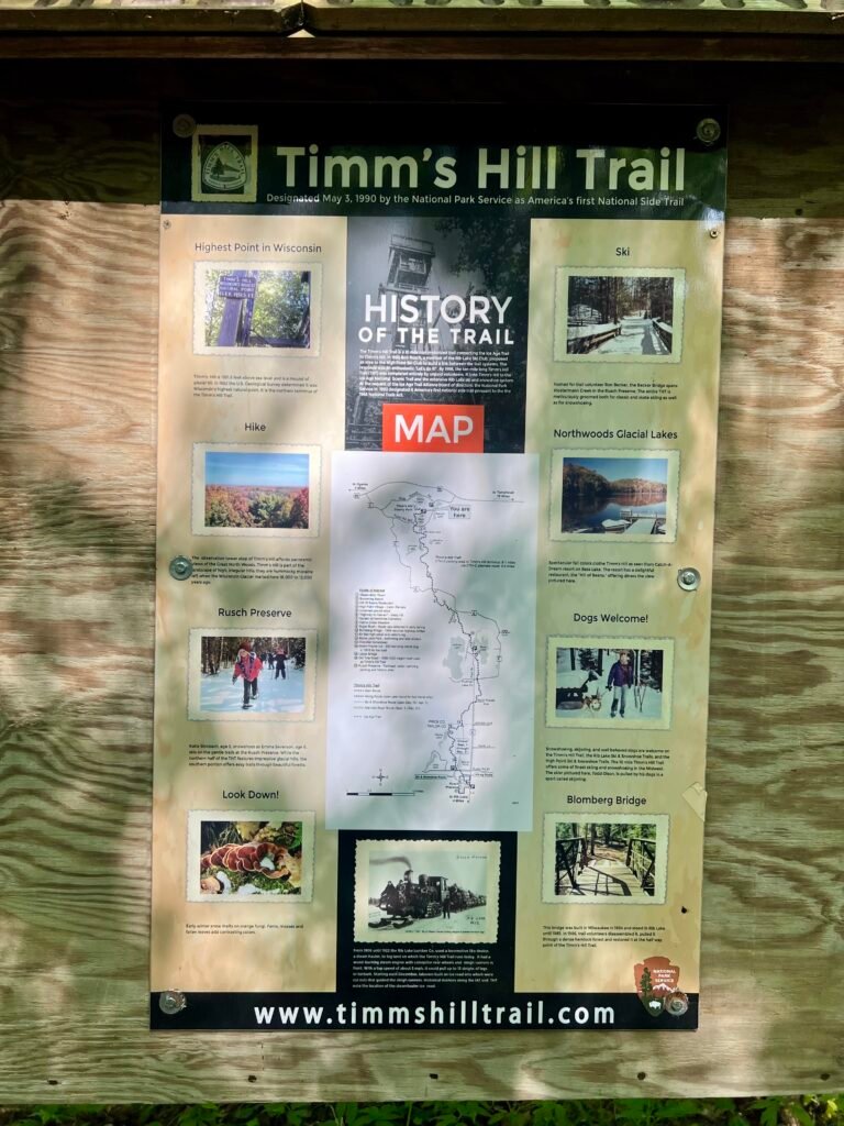 Timms Hill Trail information board with map and history details at county park in Wisconsin.
