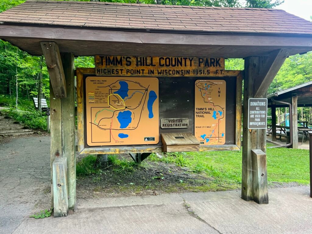 Trail map and visitor registration board at Timms Hill County Park in Wisconsin.