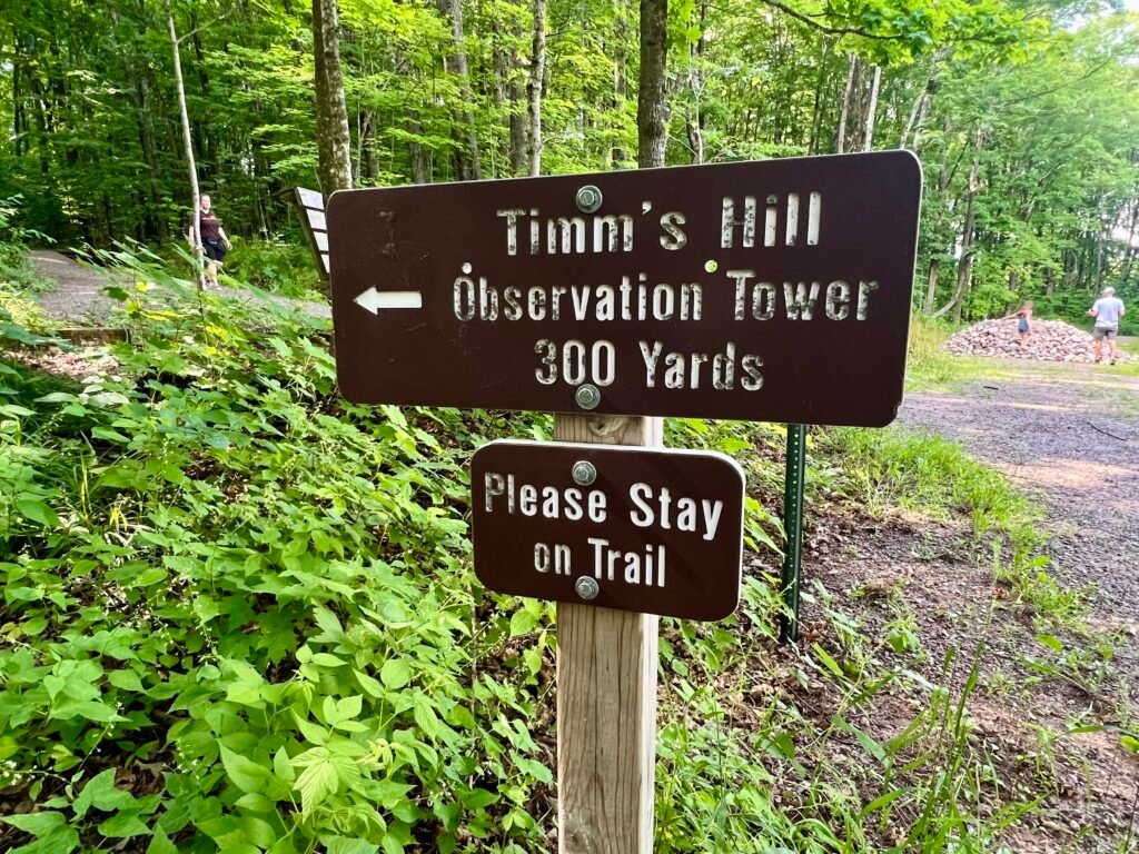 Timms Hill observation tower trail sign showing 300 yards to the summit in Wisconsin.