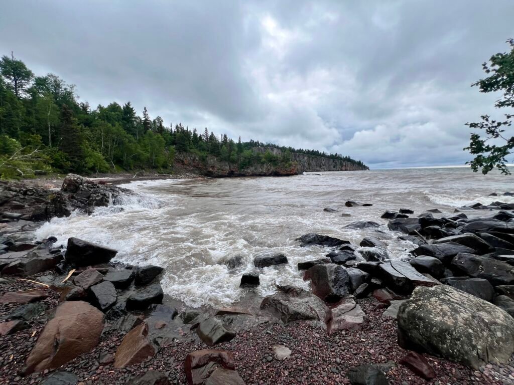 Waves crashing against rocky shoreline at Lake Superior Beach in Tettegouche State Park.