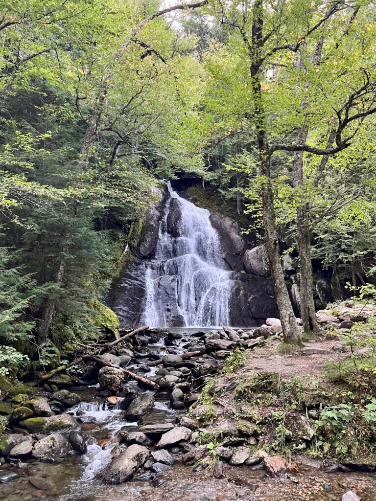 Moss Glen Falls cascading over layered rock ledges in a forested setting near Granville, Vermont.