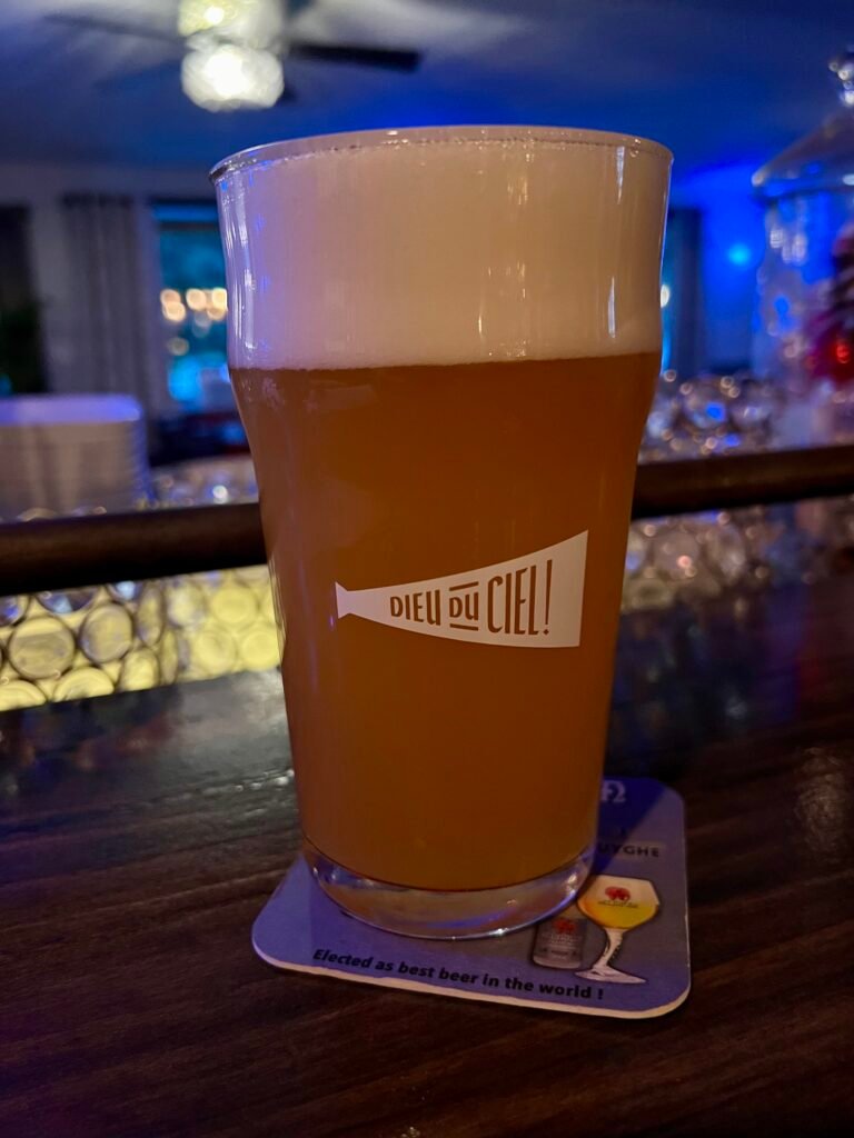 Pint of craft beer with a foamy head on the bar at Déco in Vermont.