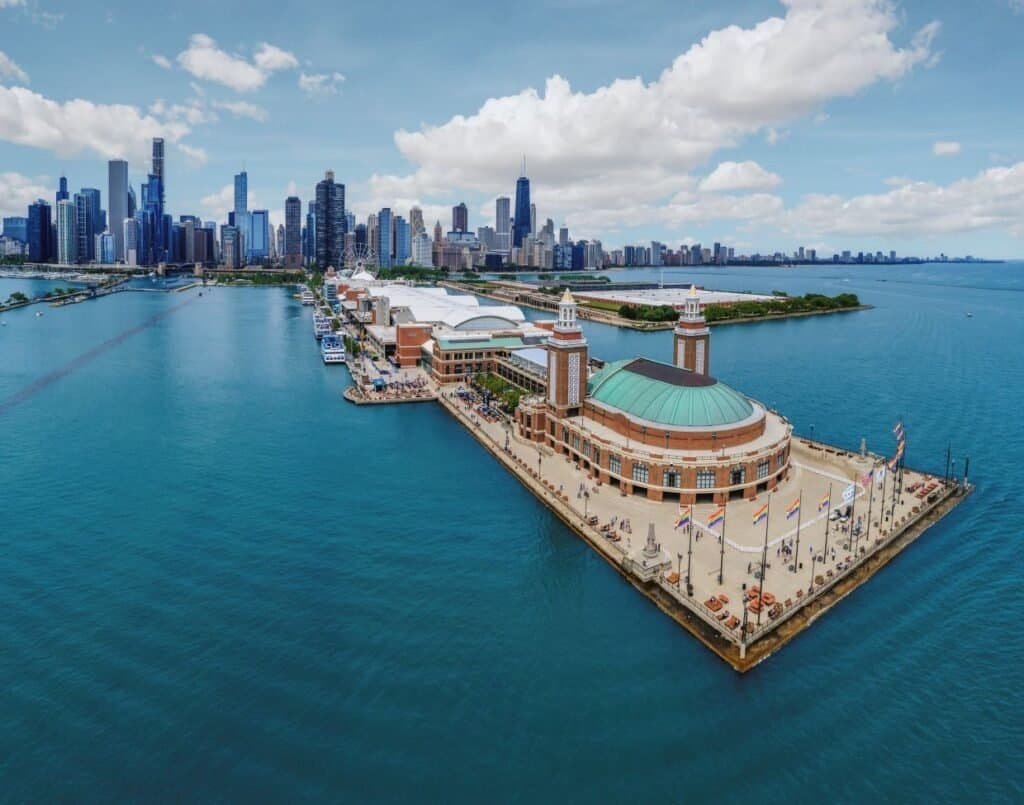 Aerial view of Navy Pier extending into Lake Michigan with downtown Chicago skyline in the background