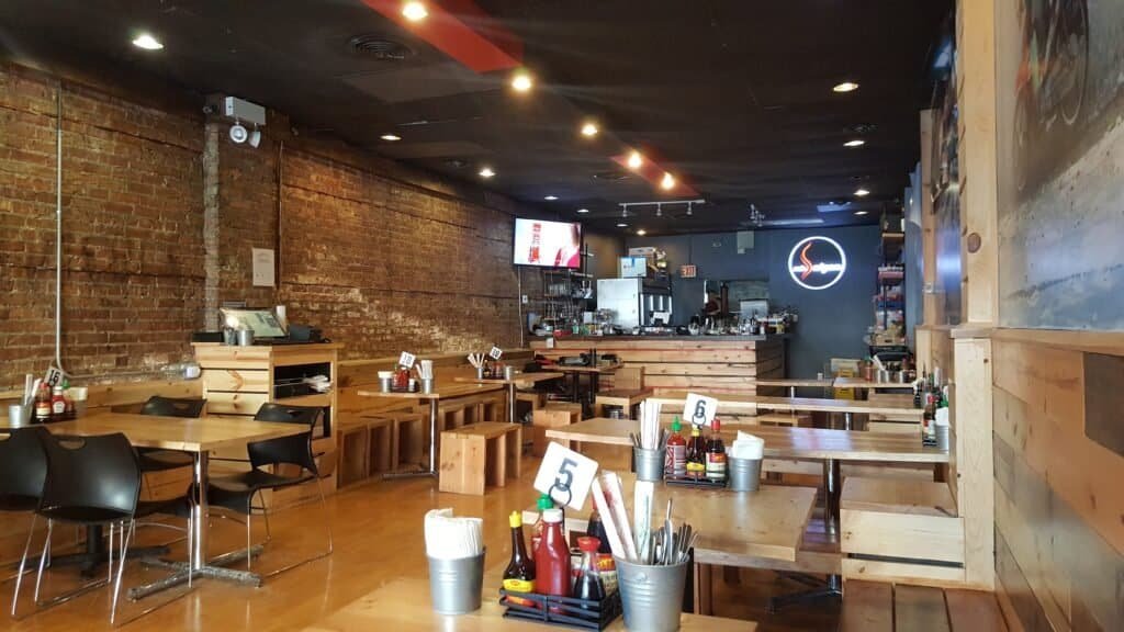 Interior seating and casual dining space inside Miss Saigon