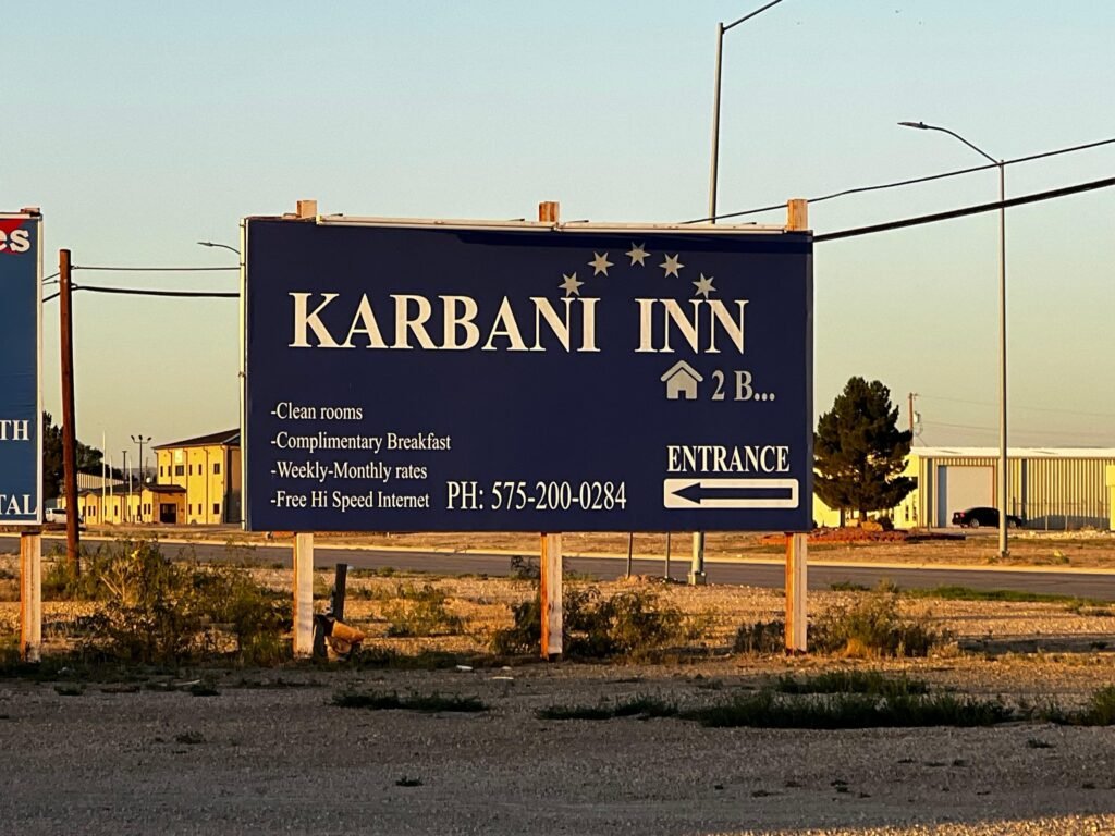 Karbani Inn roadside sign in Carlsbad, New Mexico at sunset along US-180.