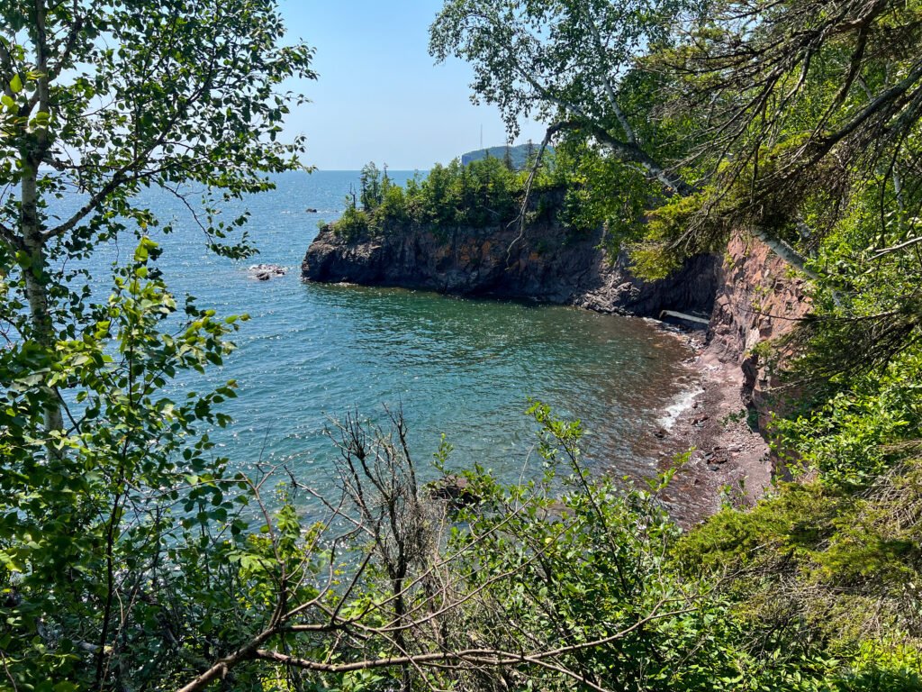 Rocky cove along Lake Superior framed by trees on Minnesota’s North Shore.