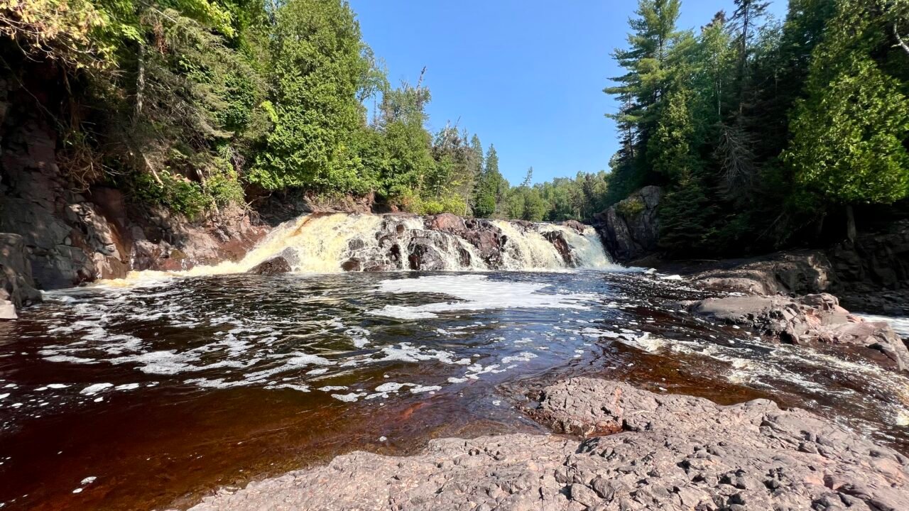 High Falls in Tettegouche State Park cascading over rocky ledges along the Baptism River on Minnesota’s North Shore.