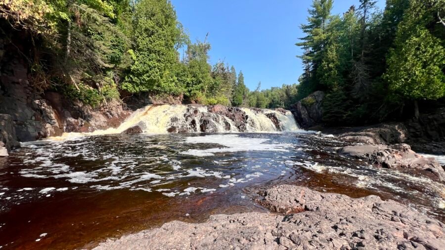High Falls in Tettegouche State Park cascading over rocky ledges along the Baptism River on Minnesota’s North Shore.