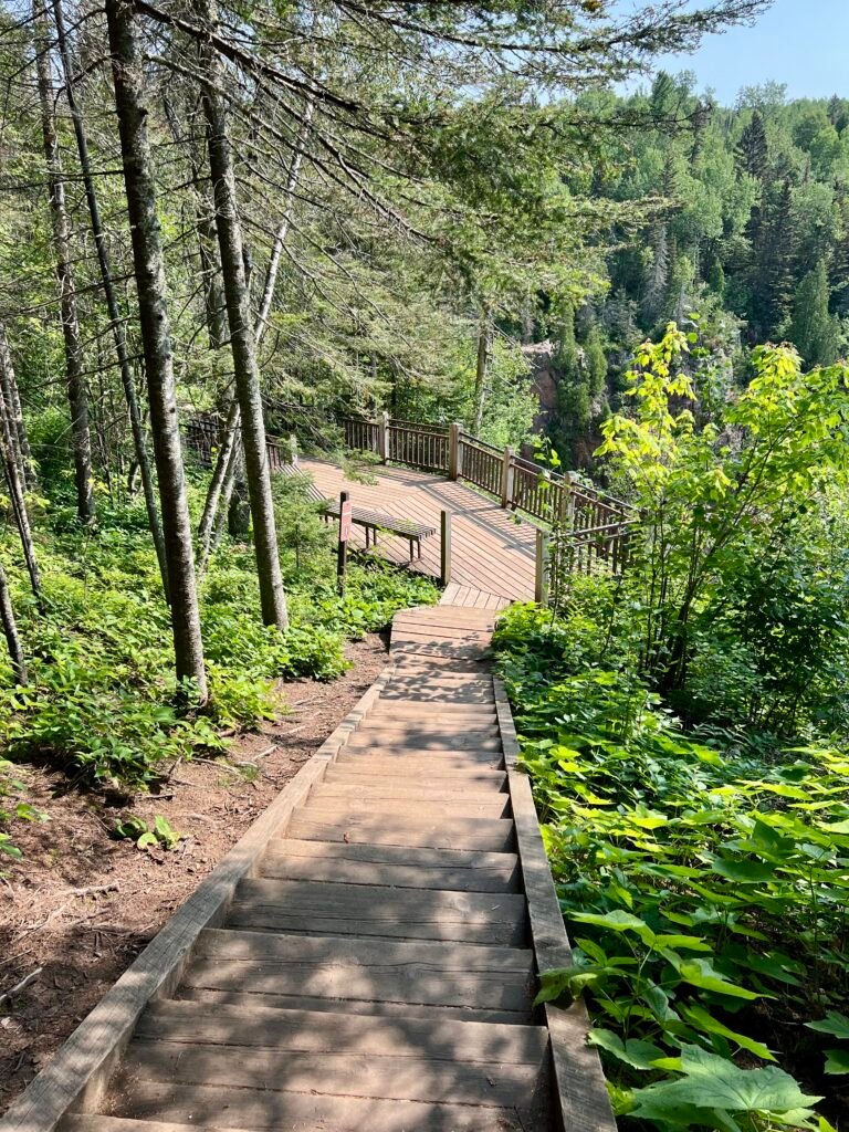 Wooden stairs leading down to the High Falls viewing platform in Tettegouche State Park, Minnesota.
