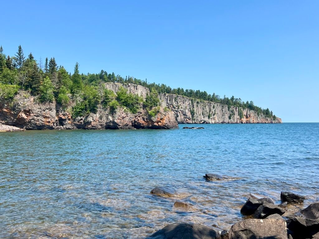 Rocky cliffs along Lake Superior viewed from the beach near Tettegouche State Park.