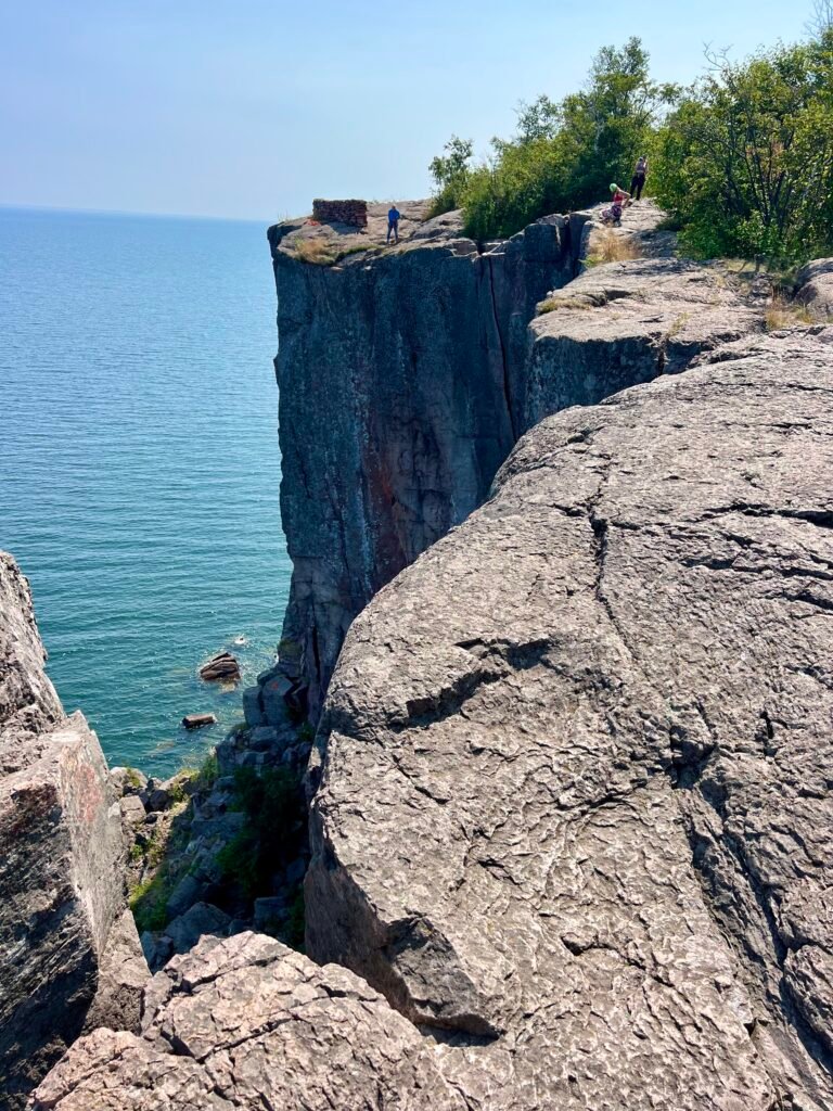 Rock climbers preparing near the edge of Palisade Head above Lake Superior.